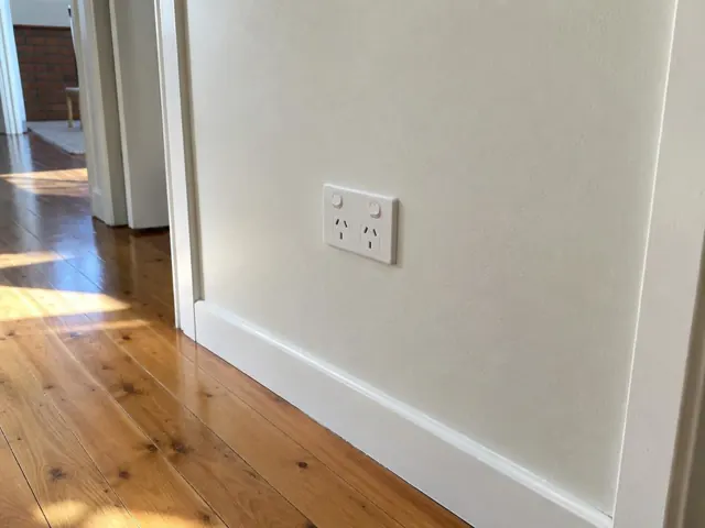 New double power point on a painted hallway wall above timber skirting in Point Clare