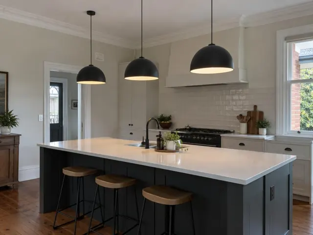 Three black pendant lights above a kitchen island in a modern home interior in Point Frederick